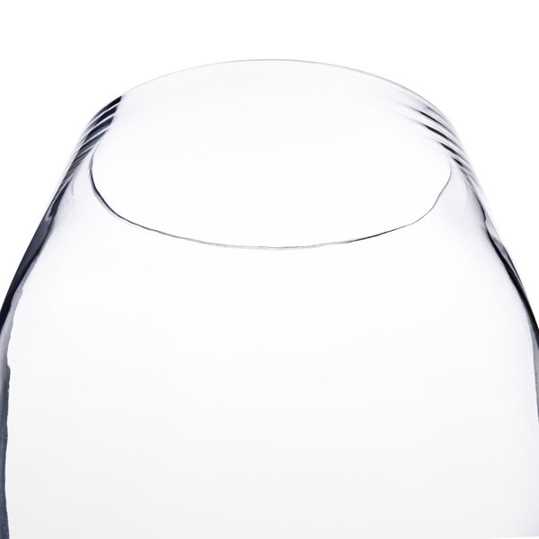A close up of a clear Thunder Group plastic wine glass.