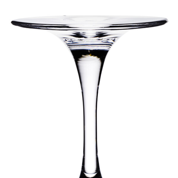 A clear Thunder Group plastic wine glass with a stem on a table in a cocktail bar.