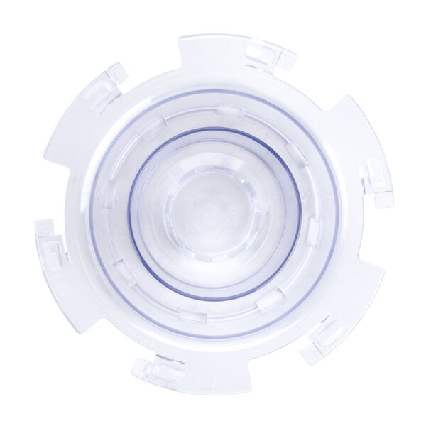 A close-up of a clear plastic circular lid with a hole.