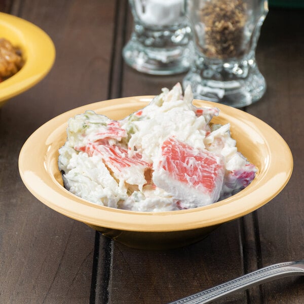 A bowl of squash melamine salad on a table.