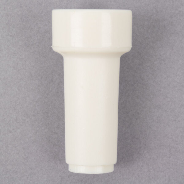 A white plastic tube with a small hole.