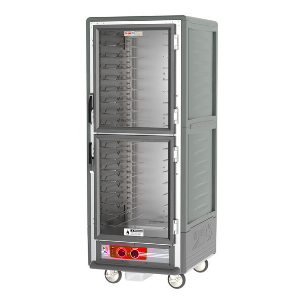 A grey Metro C5 hot holding cabinet with clear doors on wheels.