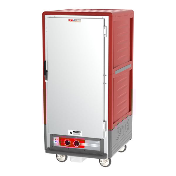A red and grey Metro C5 heated holding cabinet with wheels.