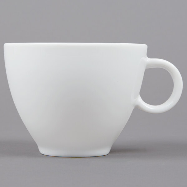 A white Arcoroc cup with a handle.