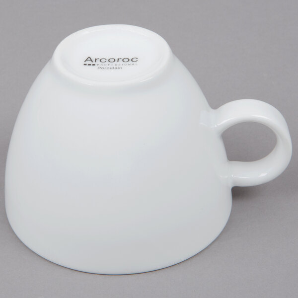 An Arcoroc white vintage coffee cup with a handle.