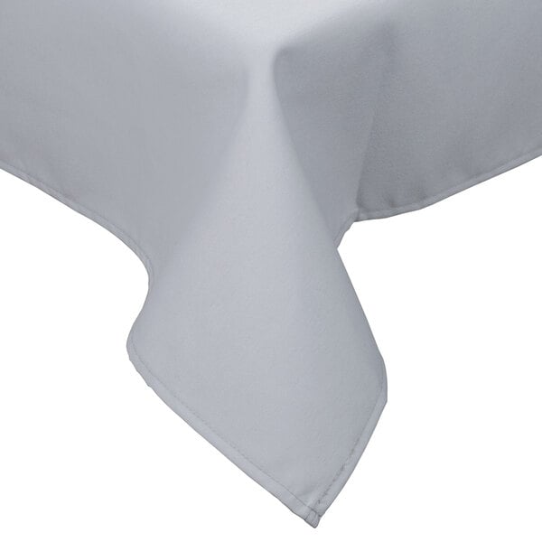 A gray rectangular poly/cotton blend table cover with a folded edge on a table.