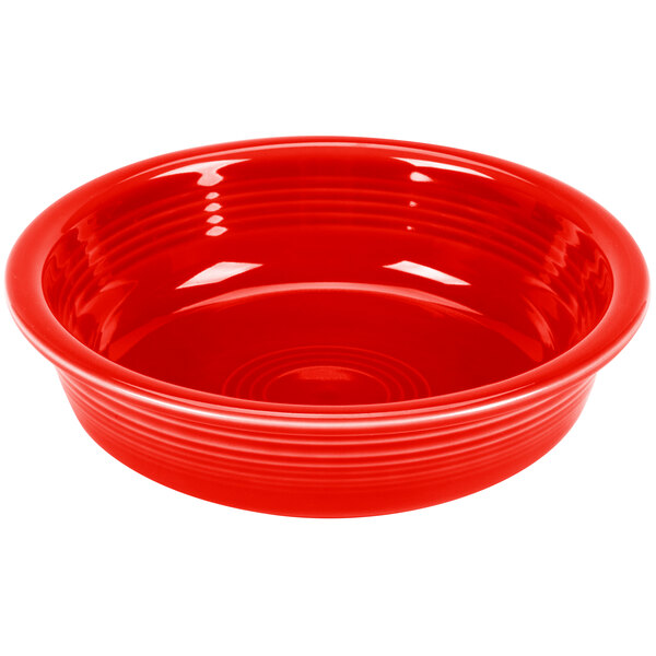 A red Fiesta china bowl with a white interior.