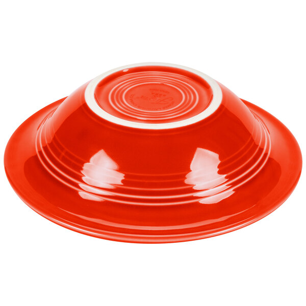 A red Fiesta china cereal bowl with a white rim.