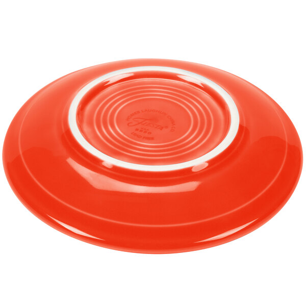 A Fiesta Poppy saucer with a white rim.