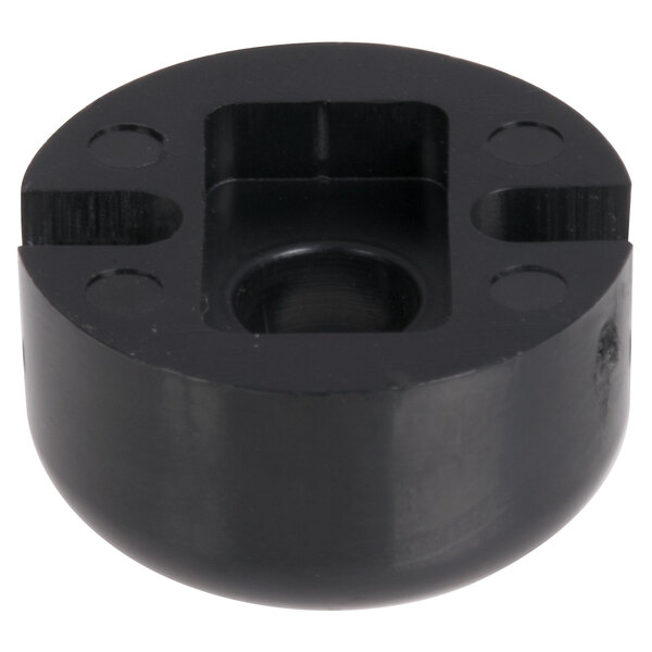 A black round plastic object with a hole in the center.