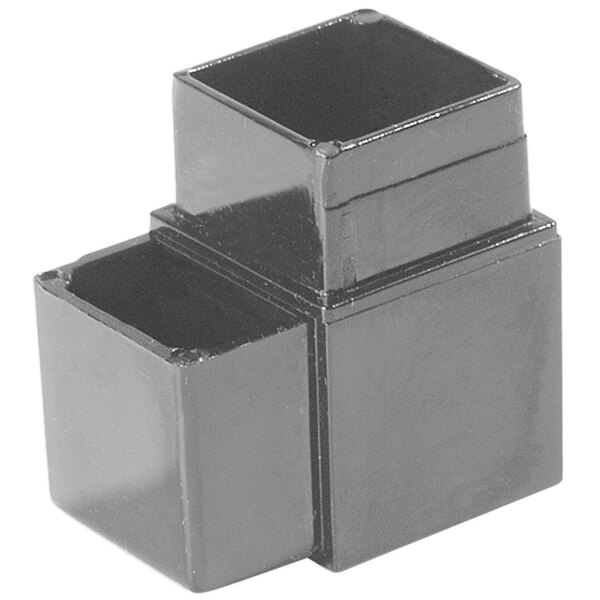 A black rectangular object with a couple of square holes in it.