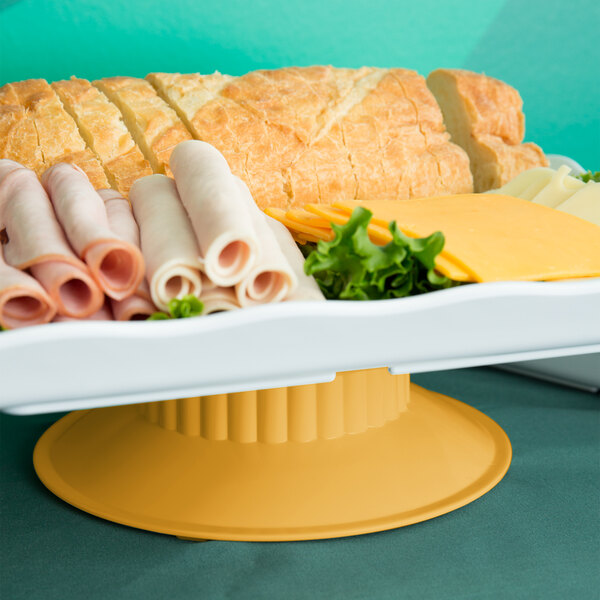 A tray of food on a GET Venetian melamine pedestal stand.