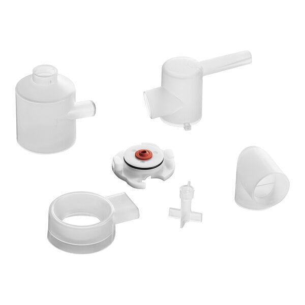 A group of white plastic parts including a white plastic container with a black circle.