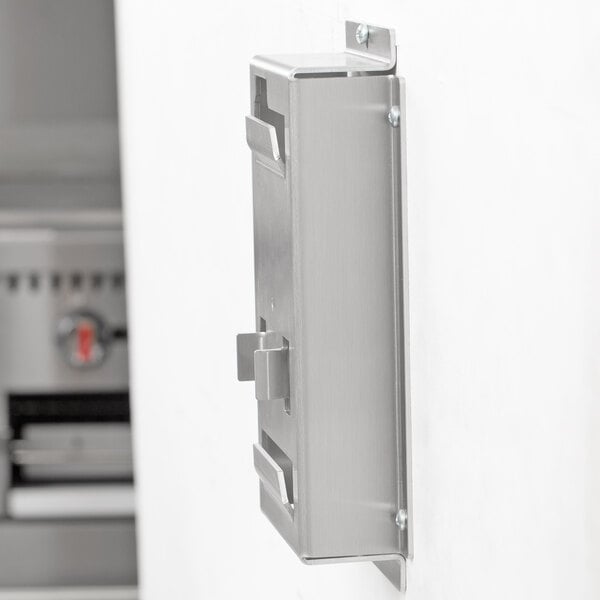 A stainless steel Edlund wall mount bracket for an FDW Series metal box on a white wall.