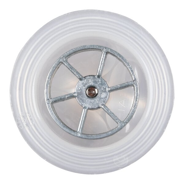 A top-down view of a circular metal component with spokes inside a translucent plastic ring, resembling a blending assembly part.
