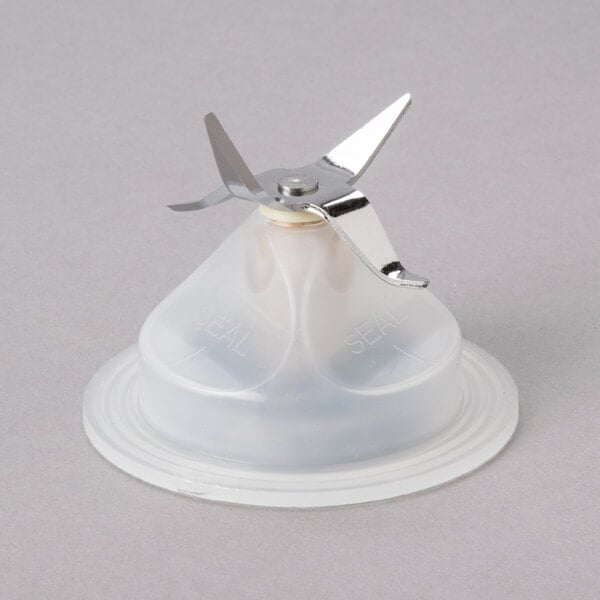 A plastic blender blade with a metal blade.