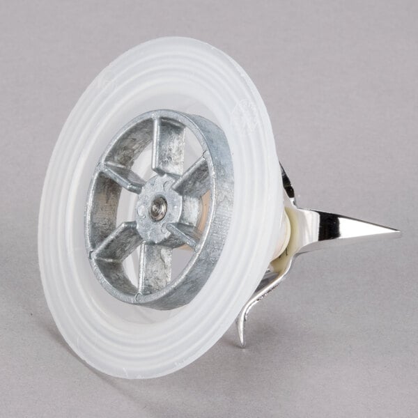 A white plastic disc with a metal rim and a silver blender wheel.