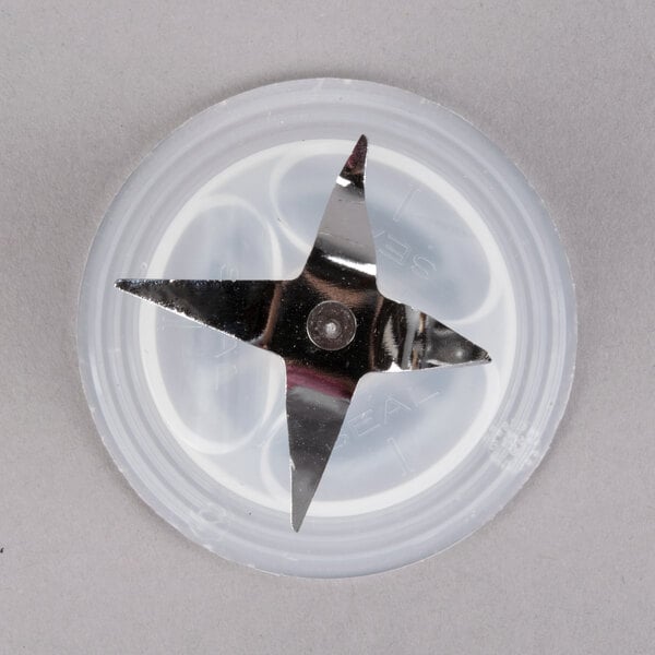 A star shaped blade on a white plastic container.