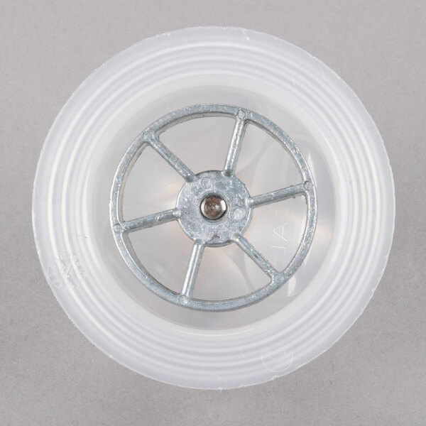 A white plastic wheel with a metal wheel in the middle.