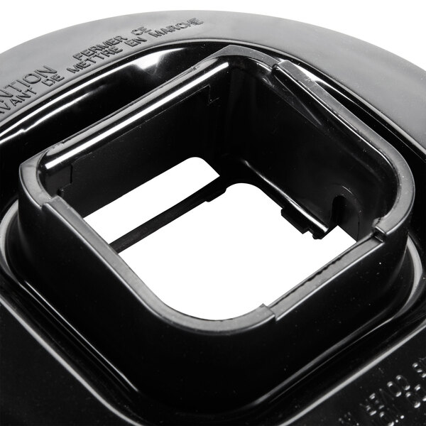 A black plastic Waring outer jar lid with a square hole in it.