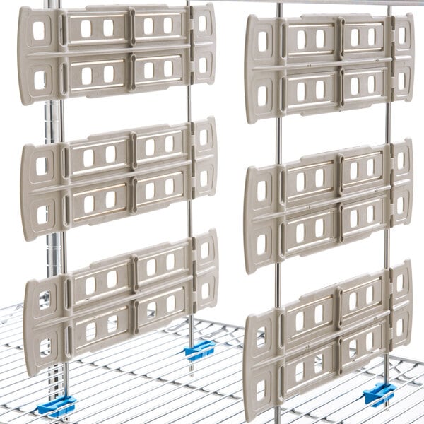 A white Metro shelf divider on a wire rack with many holes.