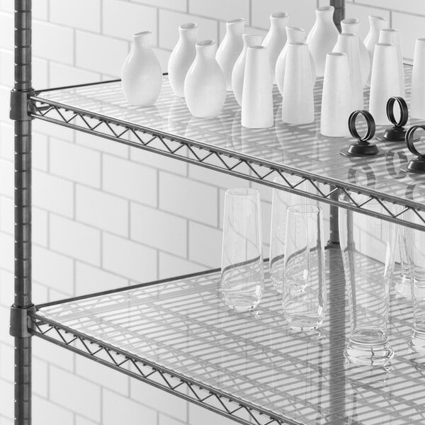 Clear PVC shelf liner on a Regency shelf with white vases and glasses.