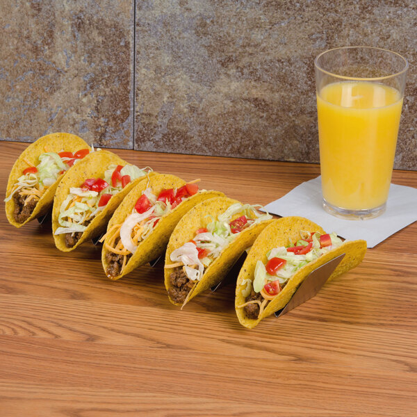 American Metalcraft stainless steel taco holder with tacos on a table.