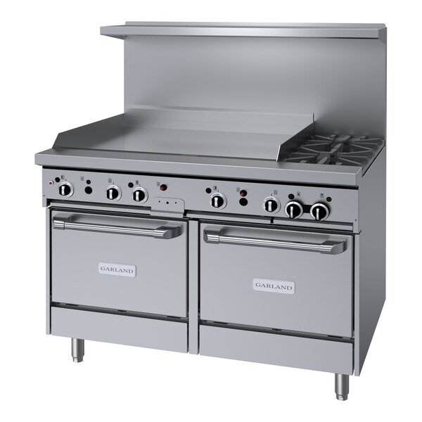 A large stainless steel Garland gas range with two burners.