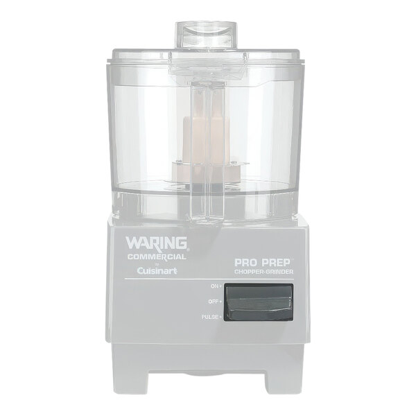 A close-up of a Waring food processor with the main switch button on the lid.