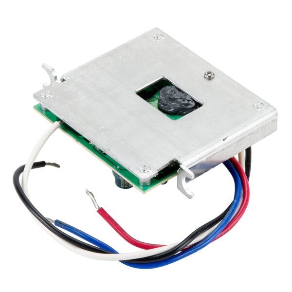 The main board for a Waring blender with a metal square and wires inside.