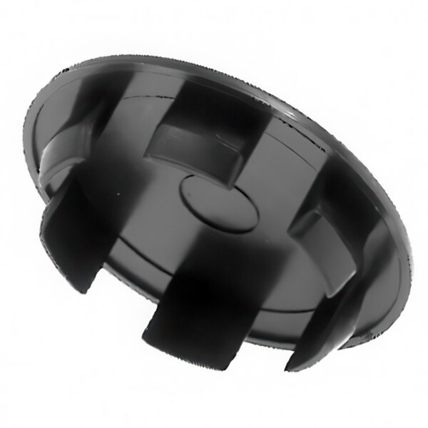 A black circular plastic cover with four holes.