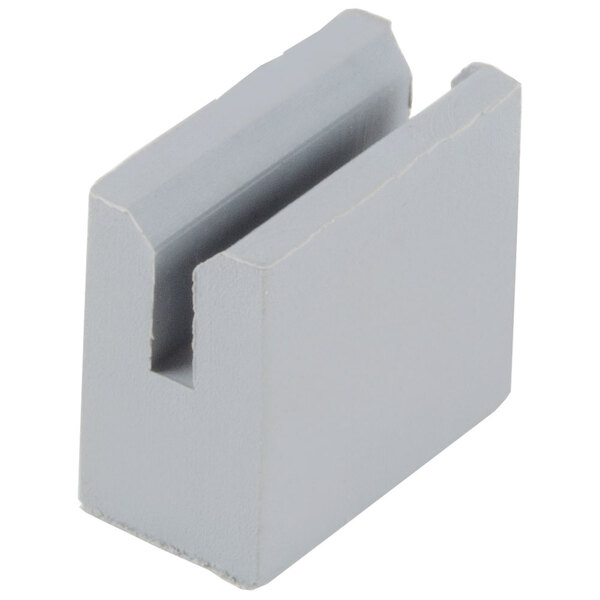 A grey plastic square cushion with two holes.