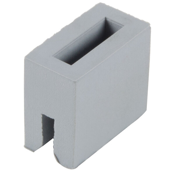 A grey rectangular object with a hole in it.