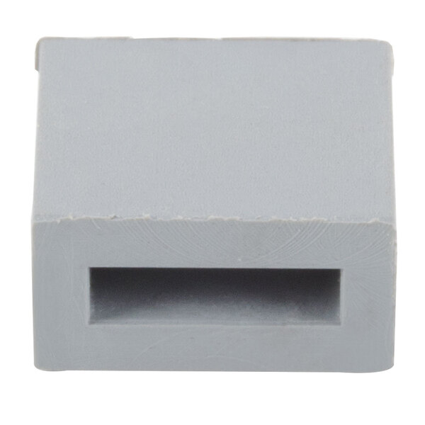 A gray plastic block with a hole in it.