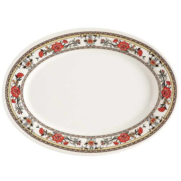 A white oval melamine platter with red flowers on it.