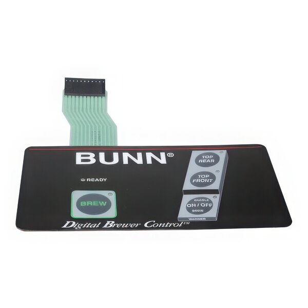 A black rectangular electronic device with a grey membrane switch with green and white text.