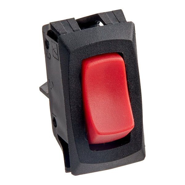 A red switch with a black plastic frame.