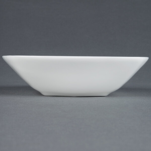 A CAC MAJ-B6 white European bone china square bowl on a grey surface.