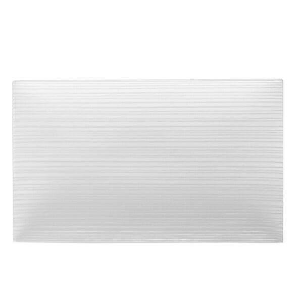 A white rectangular porcelain platter with lines.
