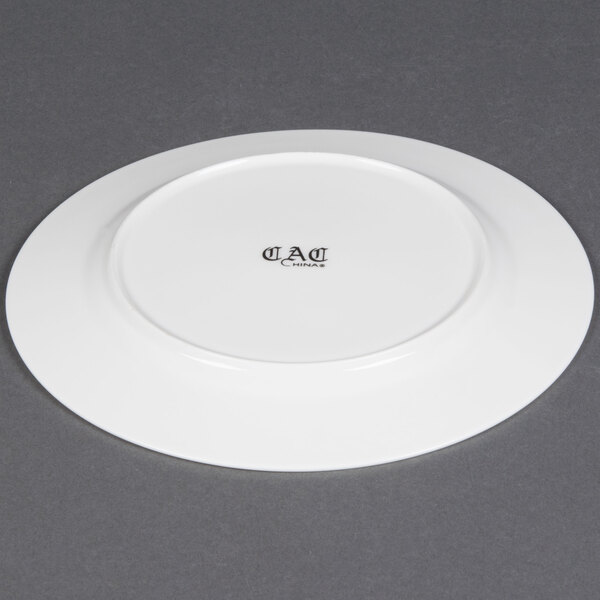 A white CAC European bone china plate with a black rim.