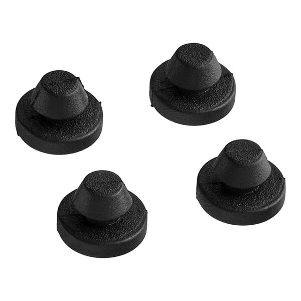 A group of black round rubber caps with a round top and hole in the center.