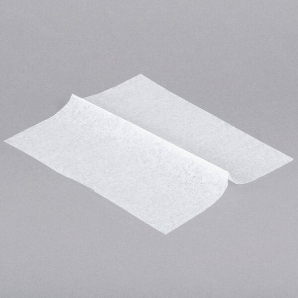 A white paper deli sheet on a gray surface.