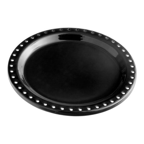 A black plate with a white circle and studded edges.