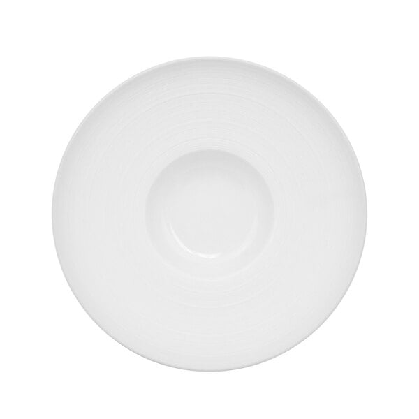 A white porcelain bowl with a circular pattern on the rim.