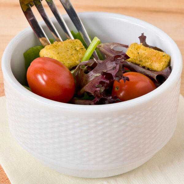 A CAC Boston porcelain nappie bowl filled with salad and a fork.