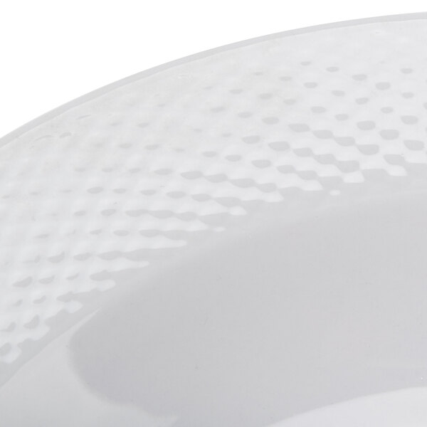 A close-up of a CAC Boston Super Bright White Porcelain Soup Bowl with an embossed pattern.