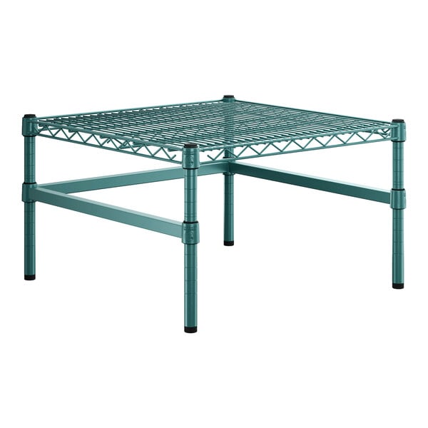 A green metal Regency wire shelf with legs.