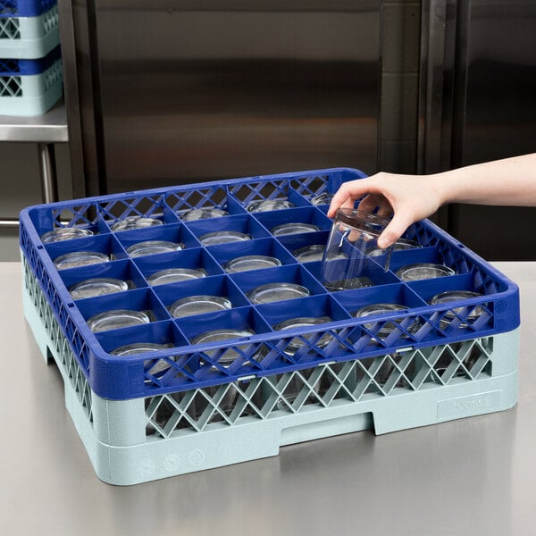 A person using a gray Noble Products glass rack with blue extenders.