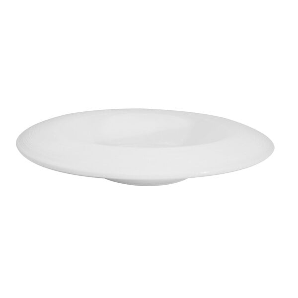 A CAC porcelain pasta bowl with a bright white draping rim on a white surface.