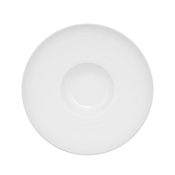 A bright white porcelain bowl with a circular pattern on the rim.